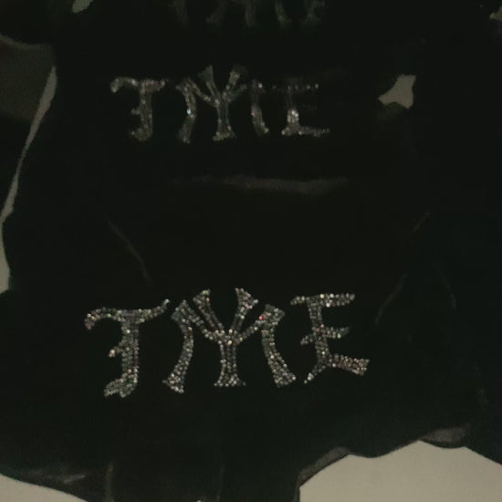 Video of custom rhinestone design on womens velour black shorts