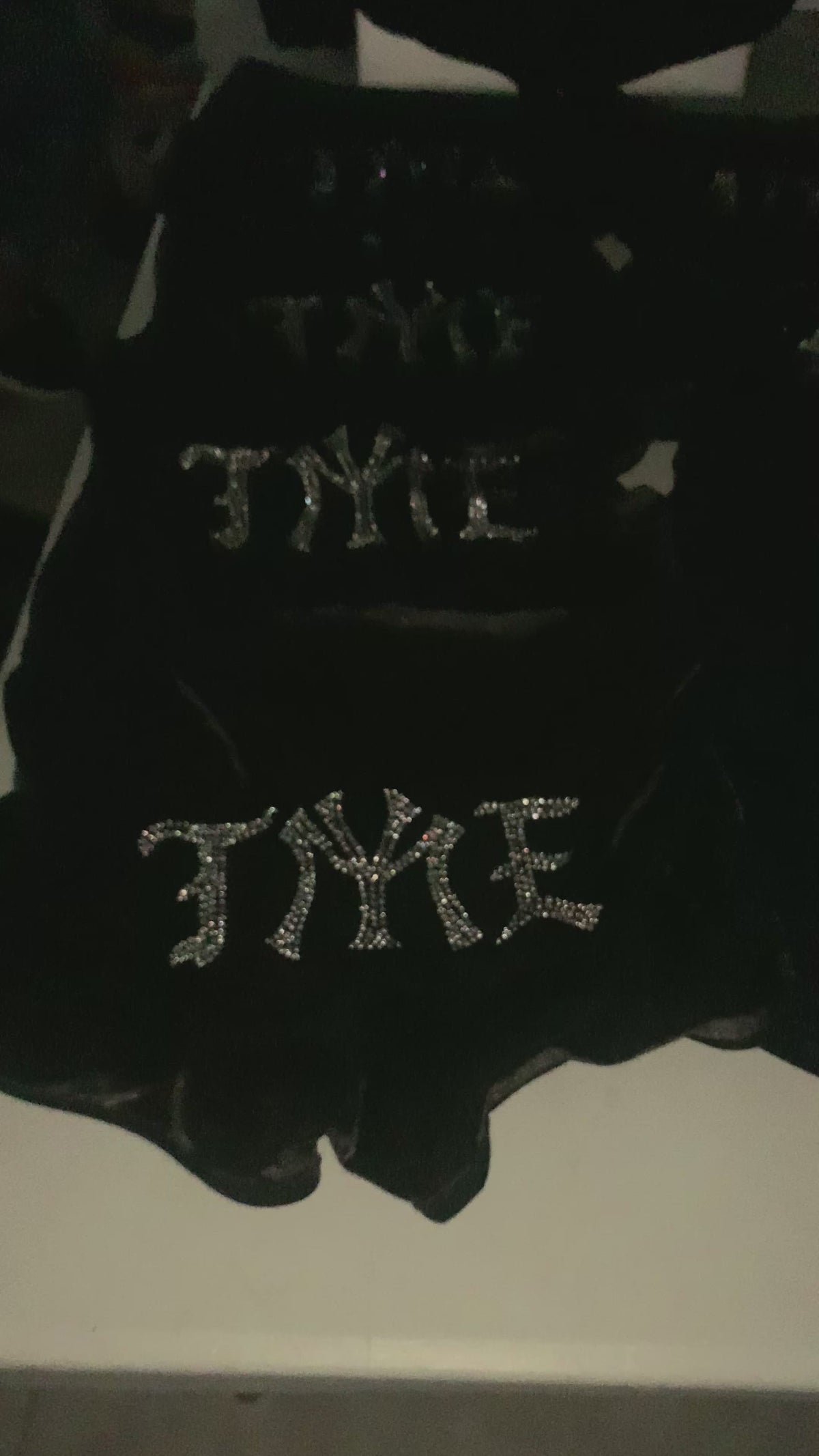 Video of custom rhinestone design on womens velour black shorts